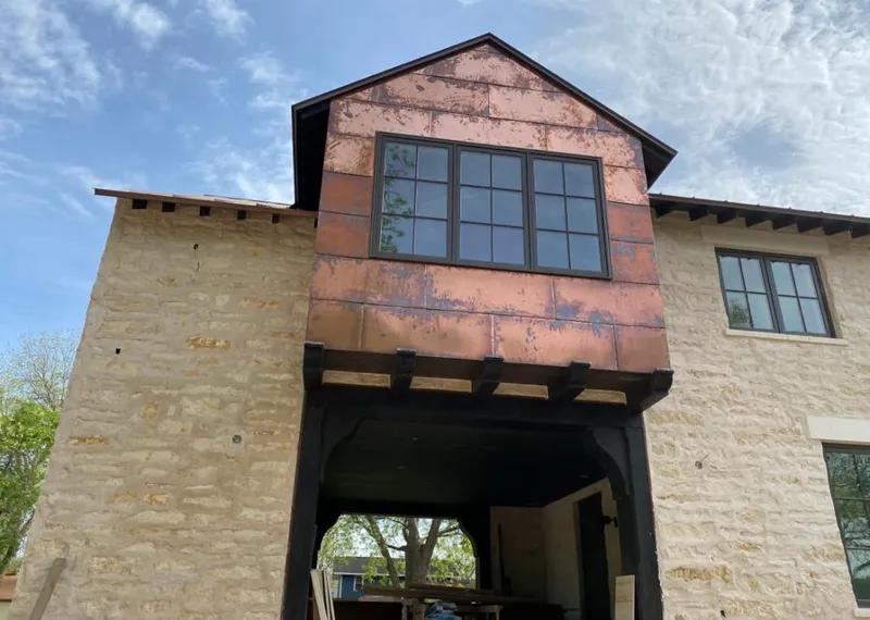 Copper metal panel facade on a stone building for Skylight Installation in California City